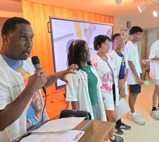 teacher with youth speak at final presentation