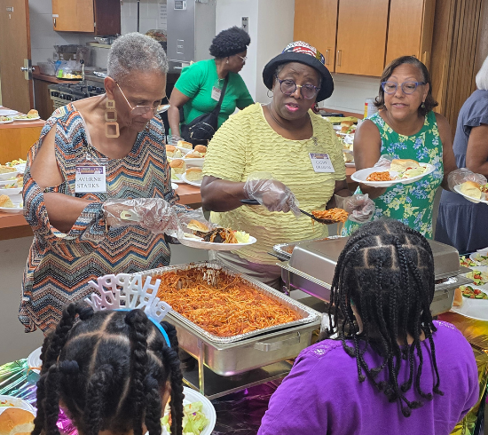 women serve food for dinner before class