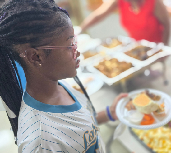 girl gets dinner plate before class