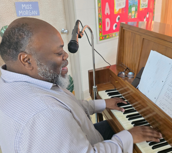 musician plays and sings during dinner before class