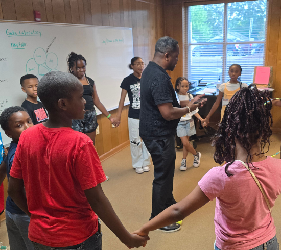 Class holding hands for prayer