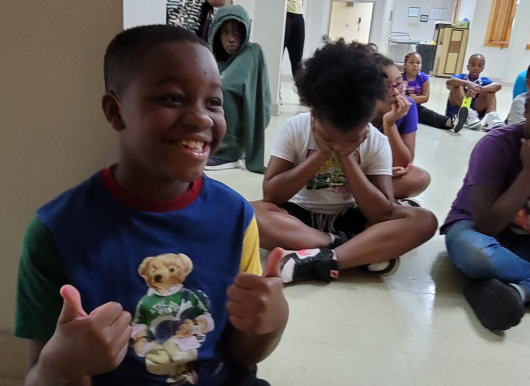 Boy smiling with thumbs up